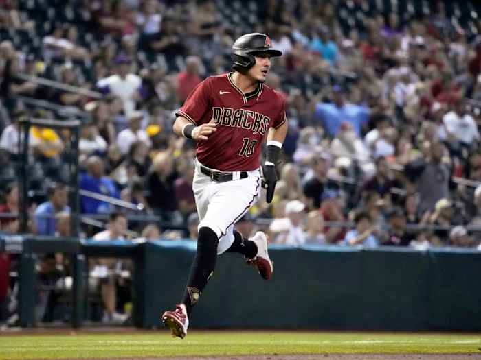 Aug 15, 2021; Phoenix, Arizona, USA; Arizona Diamondbacks third baseman Josh Rojas (10) scores a run against the San Diego Padres in the third inning at Chase Field.